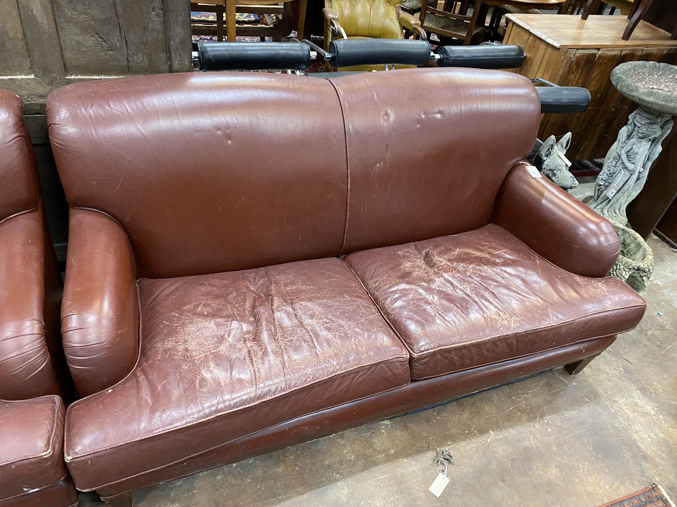 A pair of Howard style burgundy leather sofa's, width 170cm, depth 90cm, height 84cm